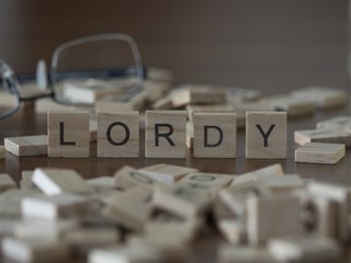The concept of lordy represented by wooden letter tiles