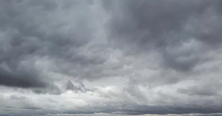 Tuinposter gllomy sky with dark gray clouds © olenadesign