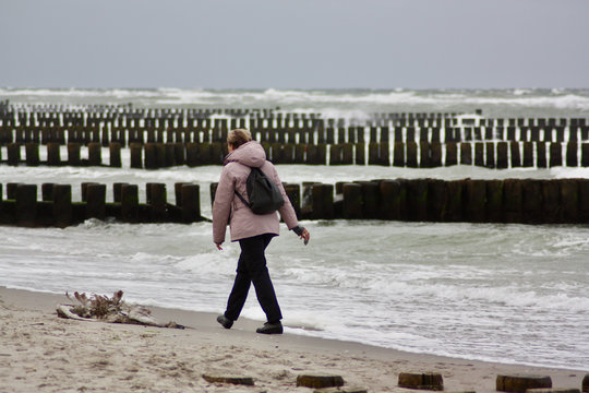lady walking by a dead crane