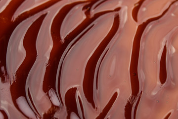 The texture of the wavy caramel closeup. View from above. Spreading caramel.