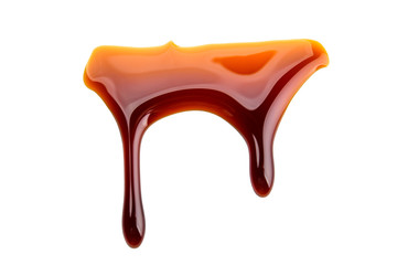 Sweet caramel sauce on a white isolated background close-up. Melted Caramel. Top view