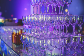 View of alcohol setting on catering banquet table, row line of different colored alcohol cocktails on a party, martini, vodka, and others on decorated catering bouquet table event