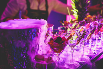 View of alcohol setting on catering banquet table, row line of different colored alcohol cocktails...