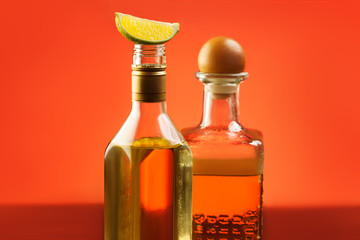 Two tequila bottles with lime - obrazy, fototapety, plakaty