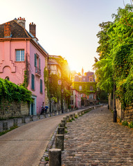 Montmartre district of Paris. Houses on narrow road in Montmartre district of Paris. View of cozy...