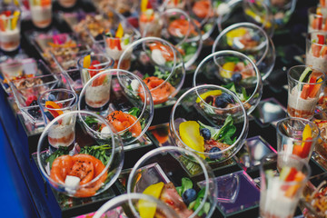 Beautifully decorated catering banquet table with different food snacks and appetizers on corporate christmas birthday party event or wedding celebration, different vegan vegetarian snacks