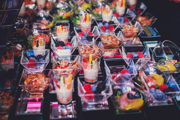 Fototapeta na wymiar Beautifully decorated catering banquet table with different food snacks and appetizers on corporate christmas birthday party event or wedding celebration, different vegan vegetarian snacks