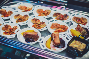 Beautifully decorated catering banquet table with different food snacks and appetizers on corporate christmas birthday party event or wedding celebration, different vegan vegetarian snacks