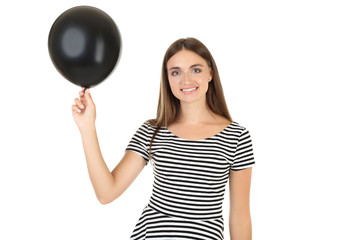 Young woman with black balloon on white background