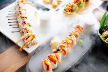 restaurant, food, people, date and holiday concept - close up sushi plate at restaurant