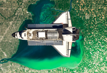 Space shuttle take off in the space from Earth. Stars and Planet on background. Atmosphere. Elements of this image furnished by NASA