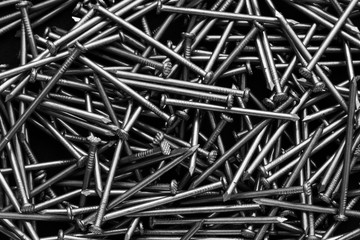 Close-up A scattering of nails. Construction Materials. Monochrome photo.