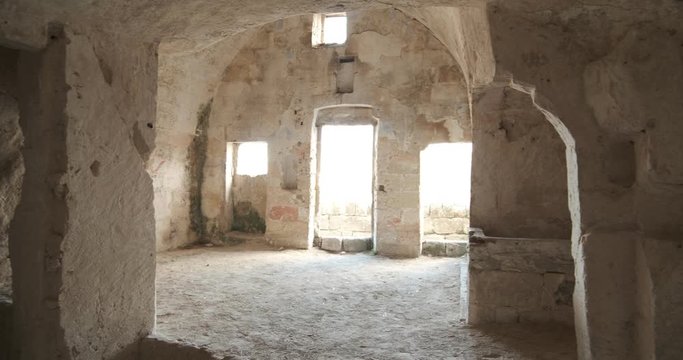 Sassi of Matera with arched ceilings and vaults. Doors and windows in an ancient underground house dug out of the tufa rock.