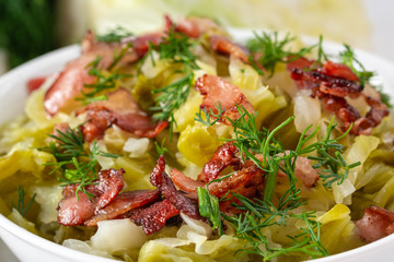 Stewed young cabbage with dill and grilled bacon.
