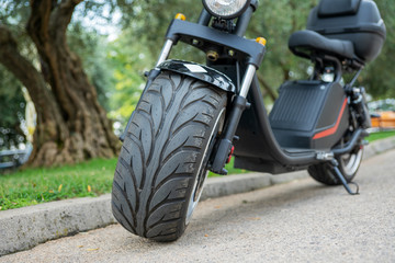 Fototapeta na wymiar Two-wheeled electric scooter with large wide wheels. Kind of straight. Selective focus.