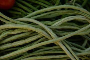 green beans is raw, harvested on wooden background. legumes, vegetarianism and gardening