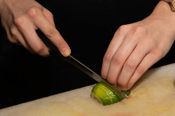 Woman hands cutting lemon on a chopping board. cocktail concept