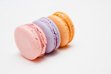 Colorful pink, orange, purple cake macaron or macaroon on white isolated background