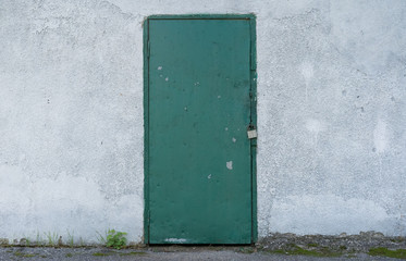 Iron door in the wall as background and texture
