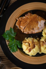 Braised pork neck in own sauce. Shallow depth of field.