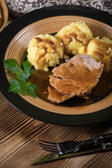 Braised pork neck in own sauce. Shallow depth of field.