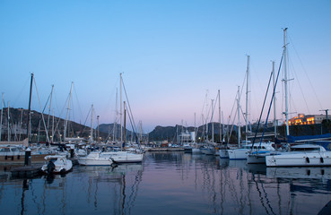 Fototapeta na wymiar wooden surface pier and boats docked at dawn in the marina of Cartajena