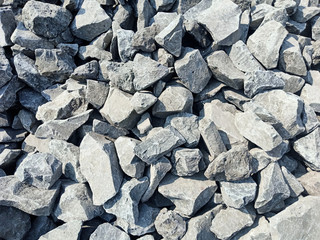 Large stones are used for construction. Arrange the rocks together the river bank