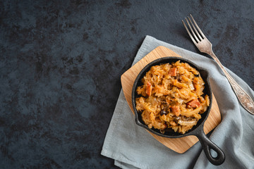 Bigos-traditional Polish dish of chopped sauerkraut and fresh cabbage with meat, mushrooms, and...