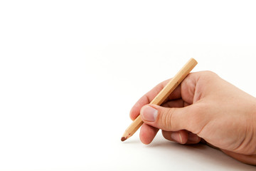 man's hand is holding a wooden brown pencil on a white background with copy space