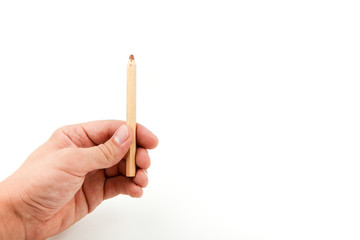 man's hand is holding a wooden brown pencil on a white background with copy space