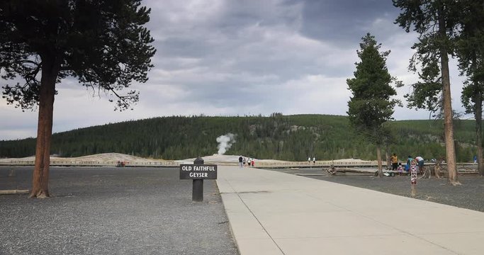 Yellowstone trail to Old Faithful geyser tourists. Cone geyser located in Yellowstone National Park in Wyoming, United States. Highly predictable geothermal ecosystem feature. Biology geography.