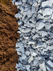 Stone and sand are used for mixing concrete in construction.