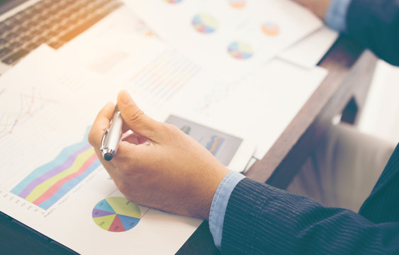Young confident men entrepreneur dressed in luxury suit smart device during work break, intelligent male using his mobile phone while preparing for business meeting in office.