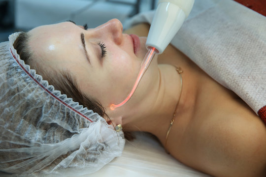 cosmetology procedure by apparatus d'arsonval close up. woman taking cosmetic procedures apparatus darsonval.