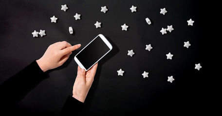 Person using a white smartphone - overhead view