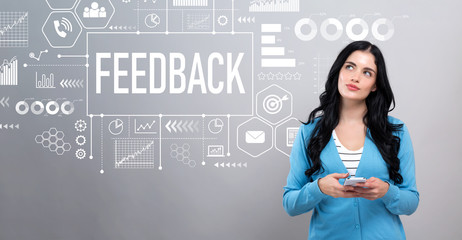 Feedback concept with thoughtful young woman holding a smartphone