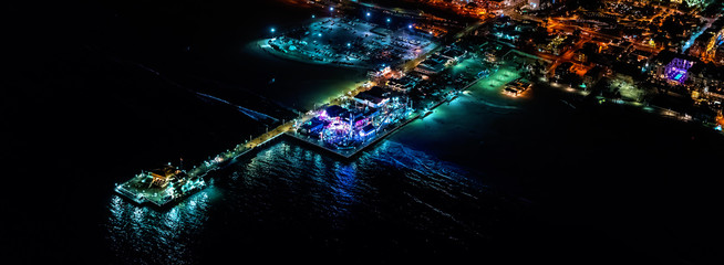 Aerial view of the Santa Monica shoreline, amusment park and pier at night