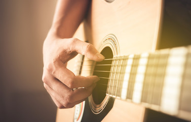 Handsome man playing guitar , close up