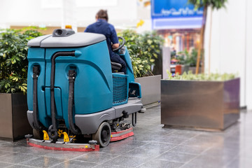 Cleaning machine for sanitation in the supermarket. Behind the wheel cleaner.