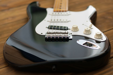 Close up of the electric guiter on the dark wooden background