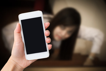 Smart phone with  black screen in hand on blurred with ghost girl background