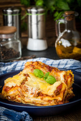 Piece of tasty hot lasagna with red wine.
