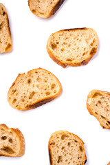 Pattern with pieces of white bread isolated on white background. Top view.