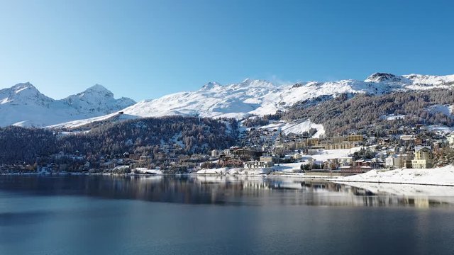 Lake of St. Moritz and beautiful Swiss village covered with snow