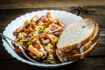 Pieces of sausage fried with egg.