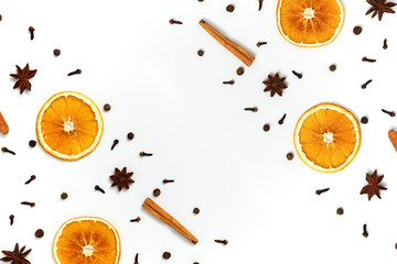 Christmas composition made of dried orange, cinnamon, black pepper, star anice and clove on white background. Set of spices for mulled wine. Top view, copy space.