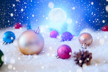 Beautiful Christmas Balls on the Snow in Night. Christmas Background. The elements of this image furnished by NASA