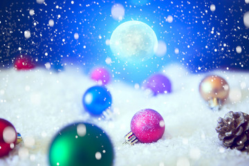 Fototapeta na wymiar Christmas background with Christmas balls on snow over fir-tree, night sky and moon. Shallow depth of field. The elements of this image furnished by NASA