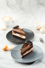 Banana chocolate cake on gray plate on marble background. Selective focus. Vertical photo. Menu for bakery. cafe menu. Pastry. Delicious and sweet dessert at cafe restaurant.