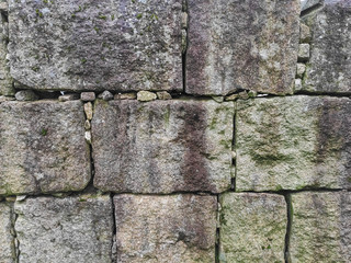 Stone wall texture with regular shaped rectangular stone blocks.